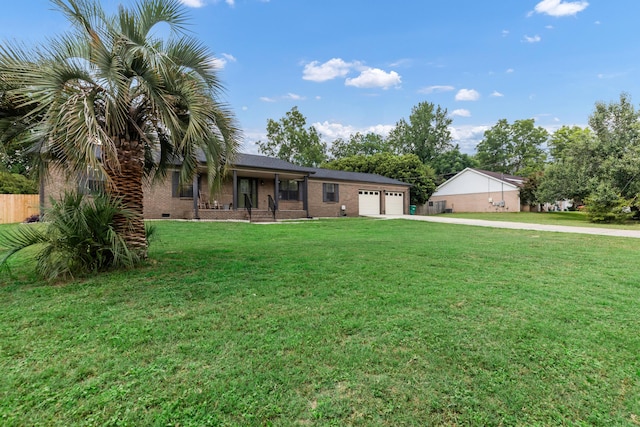 ranch-style house with a garage, a front lawn, and covered porch