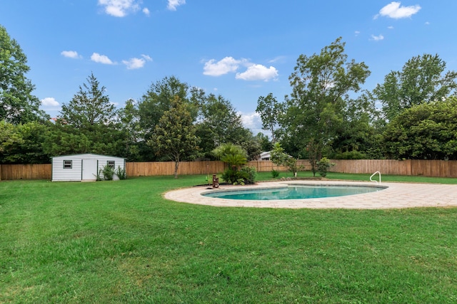 view of pool with a storage shed and a lawn