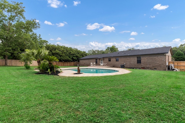 view of pool with a lawn