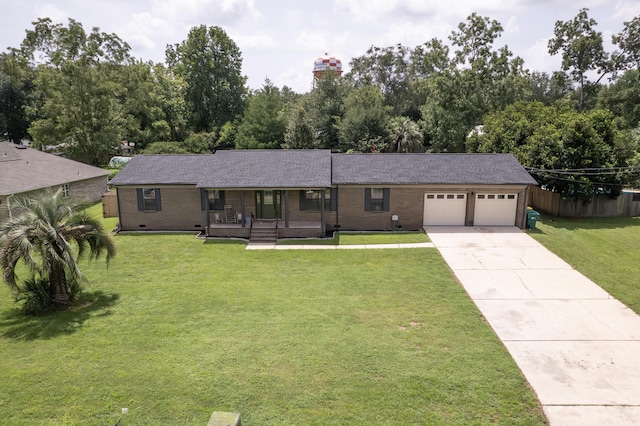 ranch-style house with a garage, covered porch, and a front lawn