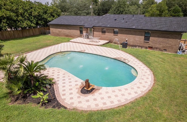 view of pool with pool water feature, a yard, and a patio