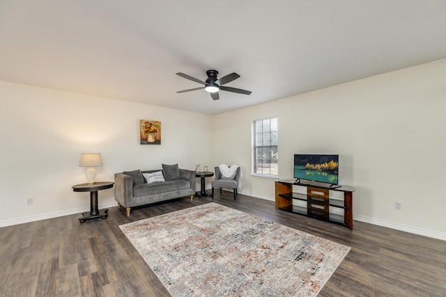 living room featuring ceiling fan and dark hardwood / wood-style flooring