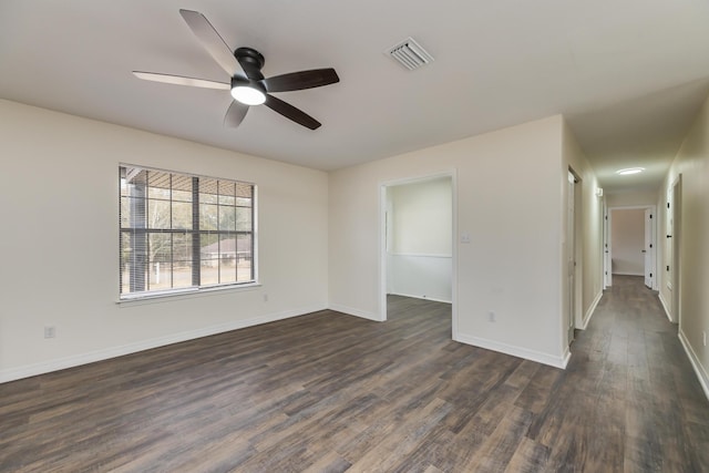 unfurnished room with dark wood-type flooring and ceiling fan