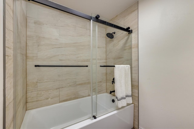 bathroom with shower / bath combination with glass door