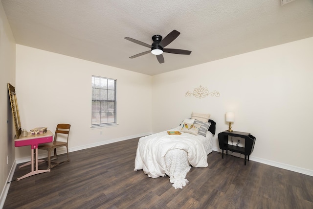 bedroom featuring ceiling fan, dark hardwood / wood-style floors, and a textured ceiling