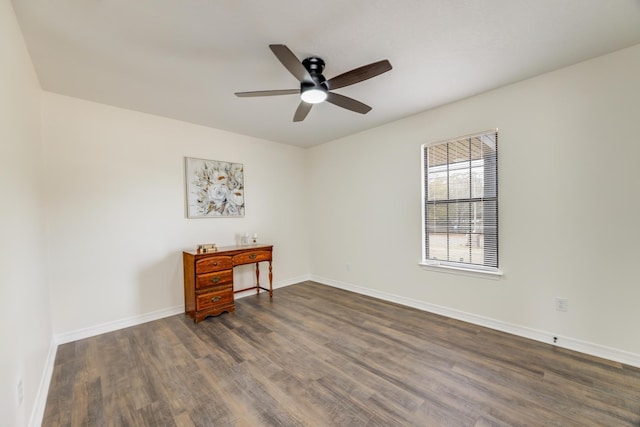 spare room with dark hardwood / wood-style floors and ceiling fan