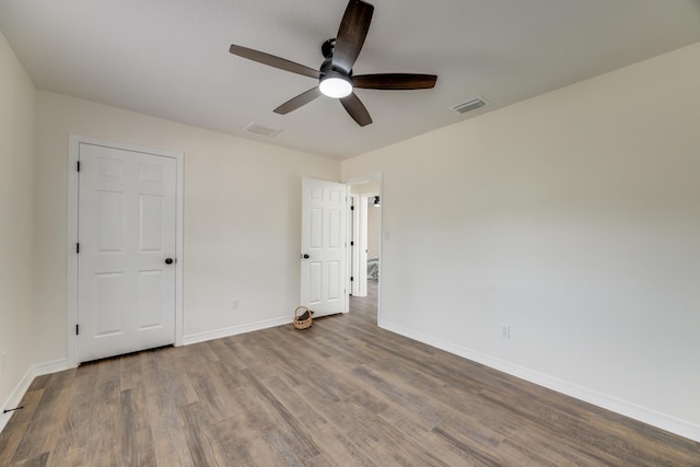 empty room with hardwood / wood-style flooring and ceiling fan