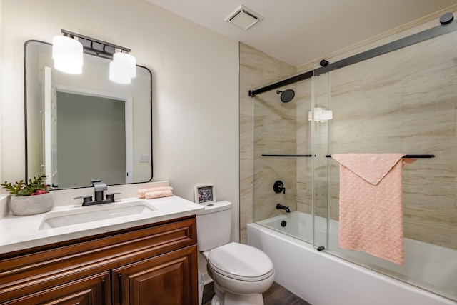 full bathroom with vanity, shower / bath combination with glass door, and toilet