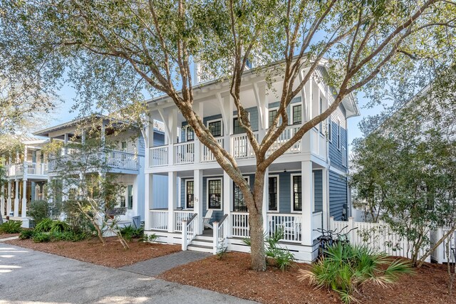 view of front of home featuring covered porch and a balcony