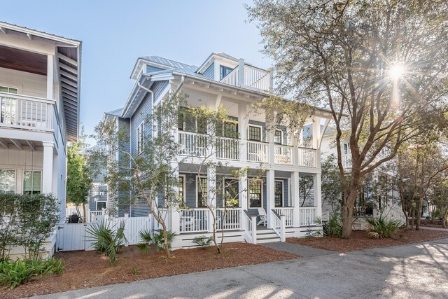 view of front facade with a balcony and covered porch