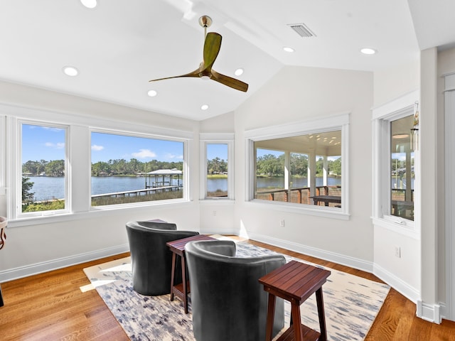 interior space featuring a water view, ceiling fan, hardwood / wood-style flooring, and lofted ceiling