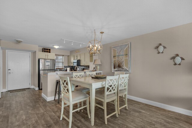 dining area featuring a chandelier and hardwood / wood-style floors