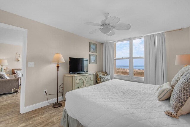 bedroom with ceiling fan and light hardwood / wood-style flooring