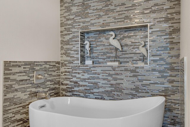 bathroom with tile walls and a bathing tub