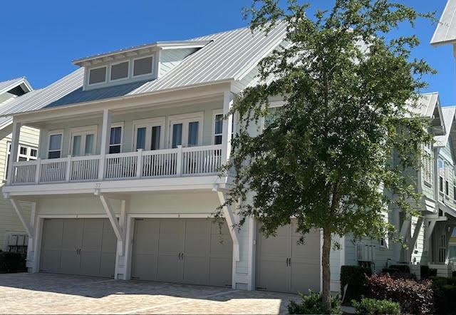 view of front facade featuring a garage and a balcony