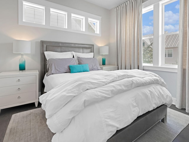 bedroom with dark wood-type flooring