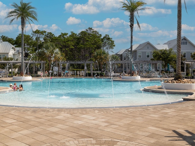 view of swimming pool featuring pool water feature and a pergola