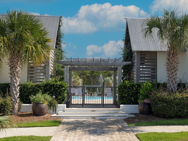 exterior space featuring a pergola and a community pool