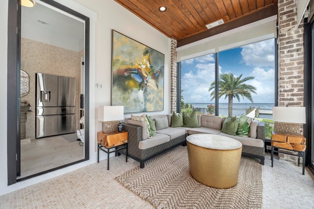 sunroom / solarium featuring a water view and wooden ceiling