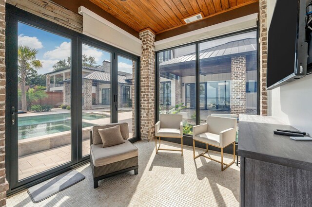 sunroom featuring wooden ceiling