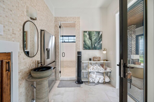 bathroom with a shower with door