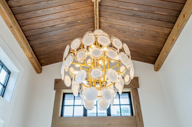 interior details featuring a chandelier, beamed ceiling, and wood ceiling