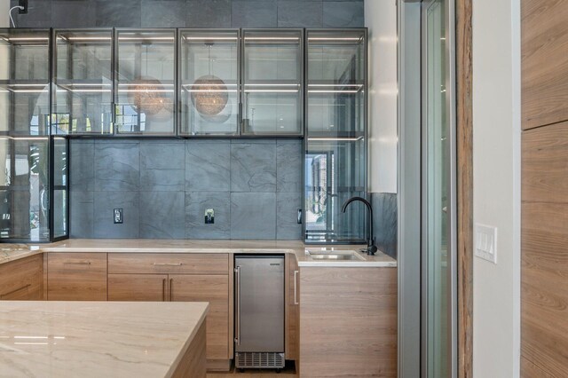 kitchen with light stone countertops and sink