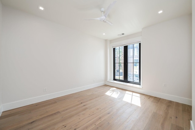 empty room featuring ceiling fan, french doors, and light hardwood / wood-style floors