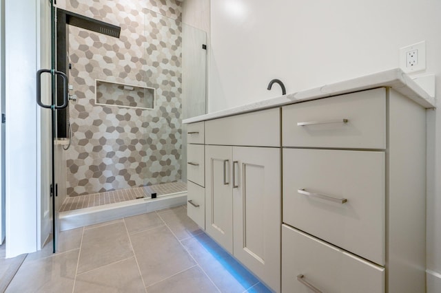 bathroom with tile patterned floors and tiled shower