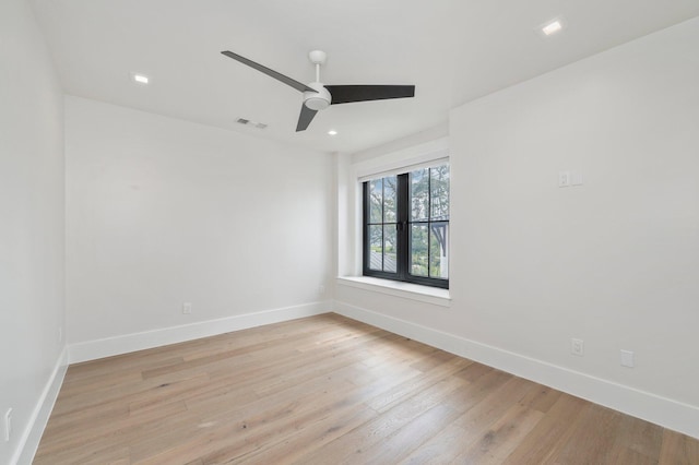 empty room featuring ceiling fan and light hardwood / wood-style floors