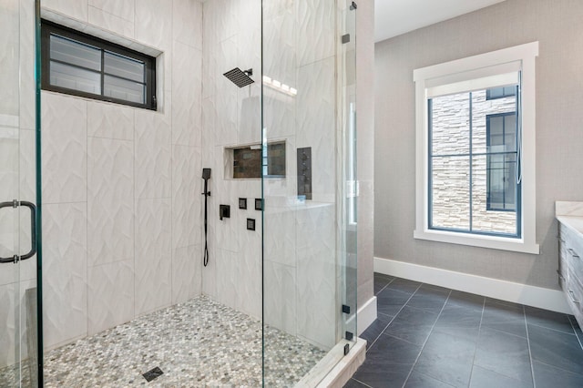 bathroom featuring tile patterned floors, plenty of natural light, vanity, and an enclosed shower