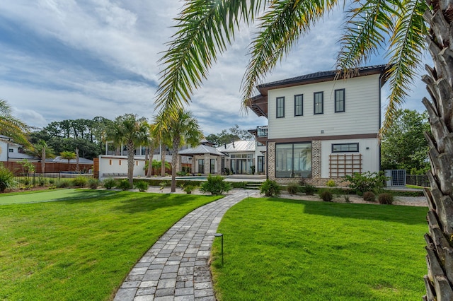 rear view of house featuring a lawn and cooling unit