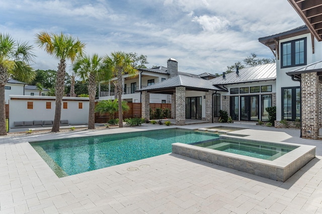 view of swimming pool with an in ground hot tub and a patio