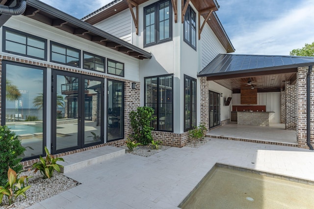 exterior space with ceiling fan and a patio area