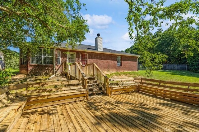 wooden terrace featuring a yard