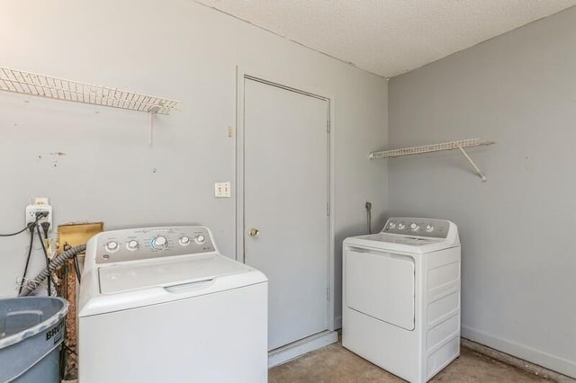 laundry area featuring washer and dryer, a textured ceiling, and hookup for a washing machine