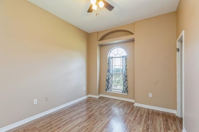 spare room featuring hardwood / wood-style flooring and ceiling fan