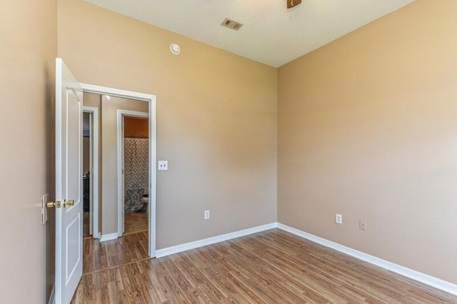 unfurnished room featuring hardwood / wood-style flooring