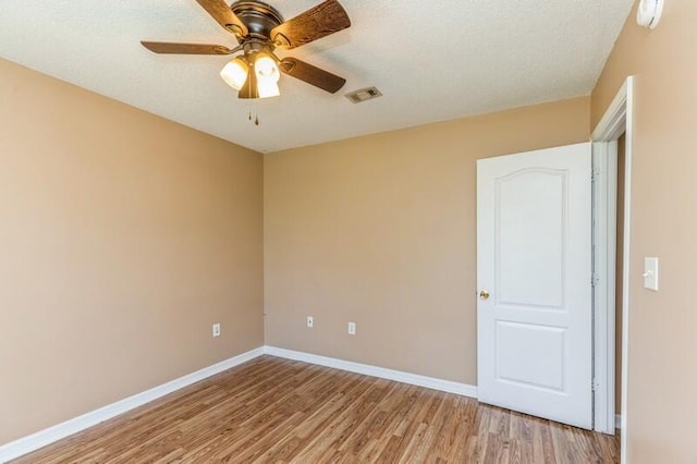 spare room featuring ceiling fan and hardwood / wood-style flooring