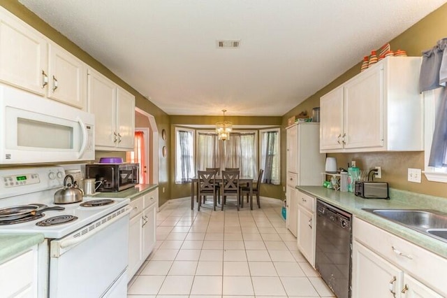 kitchen with a notable chandelier, white appliances, white cabinetry, and light tile floors