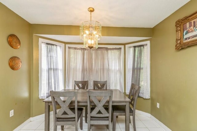 dining area featuring a wealth of natural light, a chandelier, and light tile floors