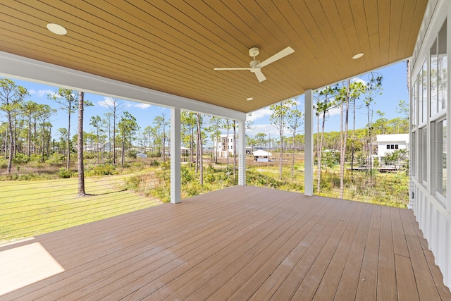 deck featuring ceiling fan and a yard