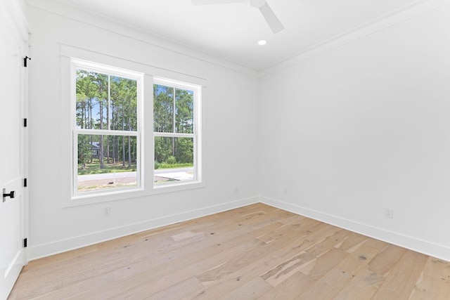 unfurnished room featuring crown molding, light wood-style floors, baseboards, and a healthy amount of sunlight