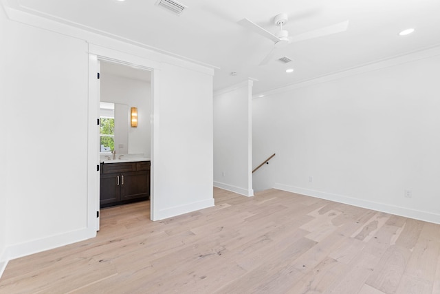 unfurnished room featuring ceiling fan, ornamental molding, visible vents, and light wood-style floors