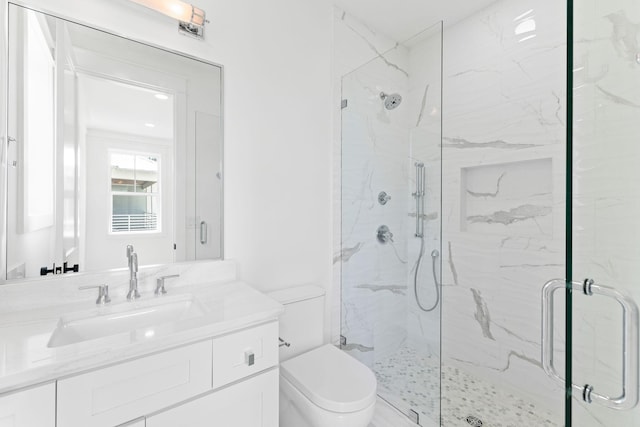 full bathroom featuring a marble finish shower, vanity, and toilet