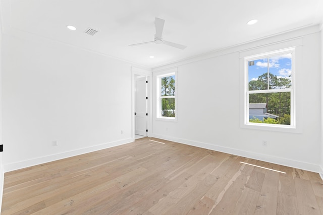 spare room with light wood finished floors, recessed lighting, visible vents, and baseboards