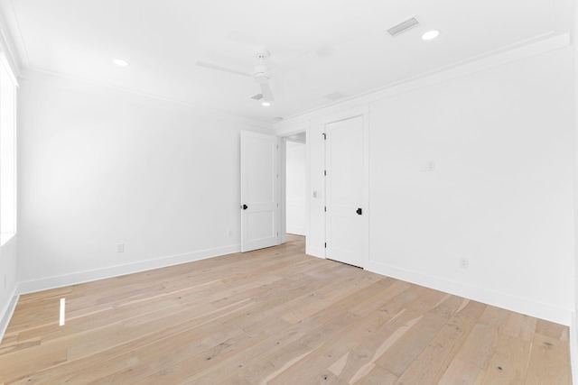 empty room featuring recessed lighting, visible vents, ornamental molding, light wood-style floors, and baseboards