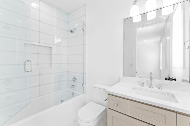 full bathroom featuring enclosed tub / shower combo, vanity, and toilet