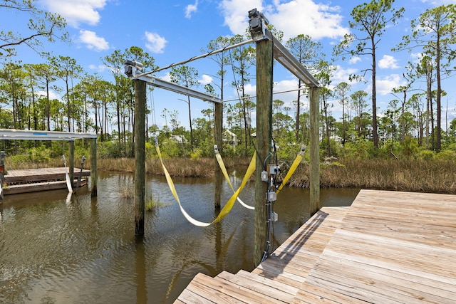 view of dock featuring a water view and boat lift