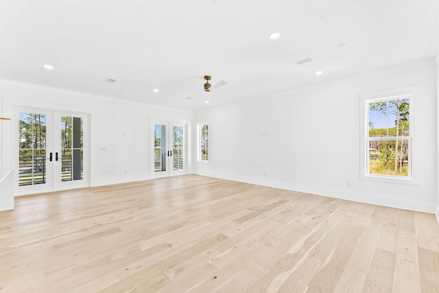 unfurnished living room featuring french doors, light wood-type flooring, and plenty of natural light